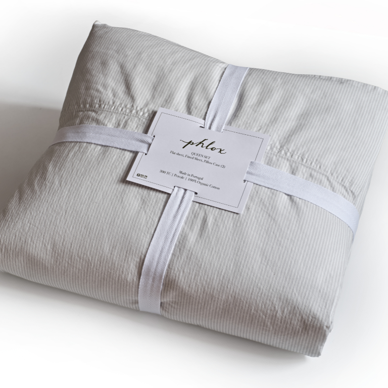 Folded gray striped fabric with a label on a white background. 100% Organic percale cotton bed sheets. 
