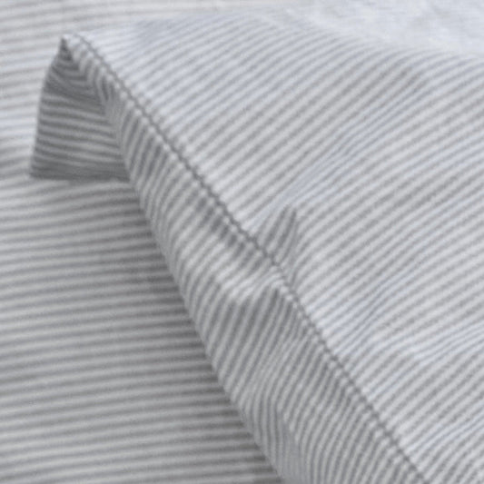 Close-up of gray striped fabric with a subtle pattern.100% Organic percale cotton.