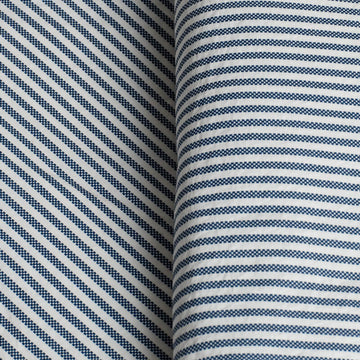 Close-up of fabric with blue and white striped pattern. 100% Organic percale cotton bed sheets. 