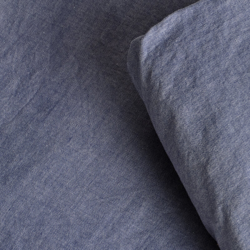 Close-up of chambray fabric texture. 100% Organic sateen cotton bed sheets. 