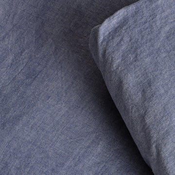 Close-up of chambray fabric texture. 100% Organic sateen cotton bed sheets. 