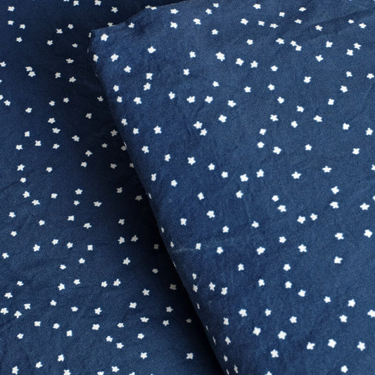 Navy blue fabric with small white floral patterns. 100% Organic percale cotton bed sheets. 